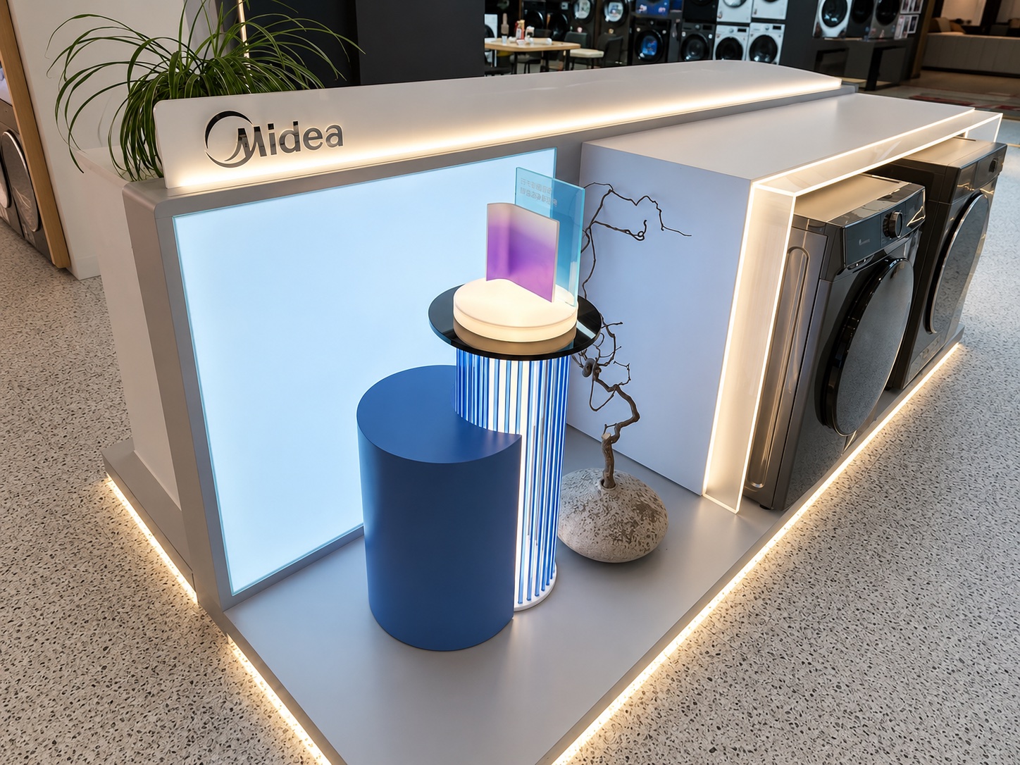 Midea illuminated product display with washing machines, dryers and branded fixture details