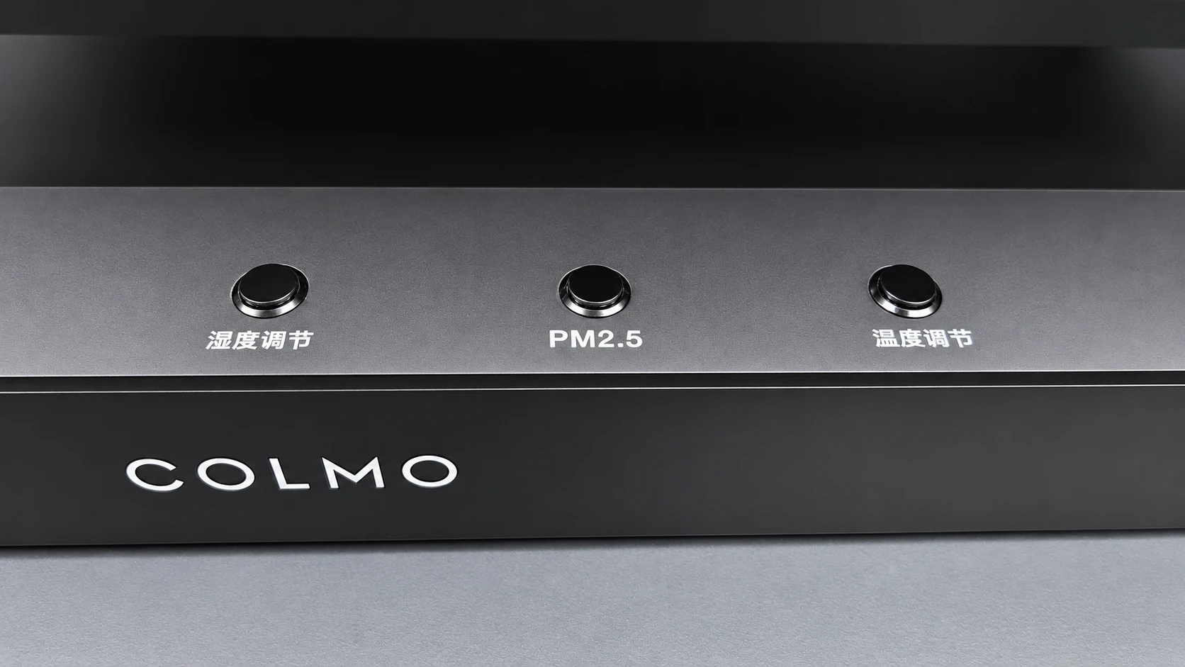 Close view of the three labelled buttons on the COLMO control panel