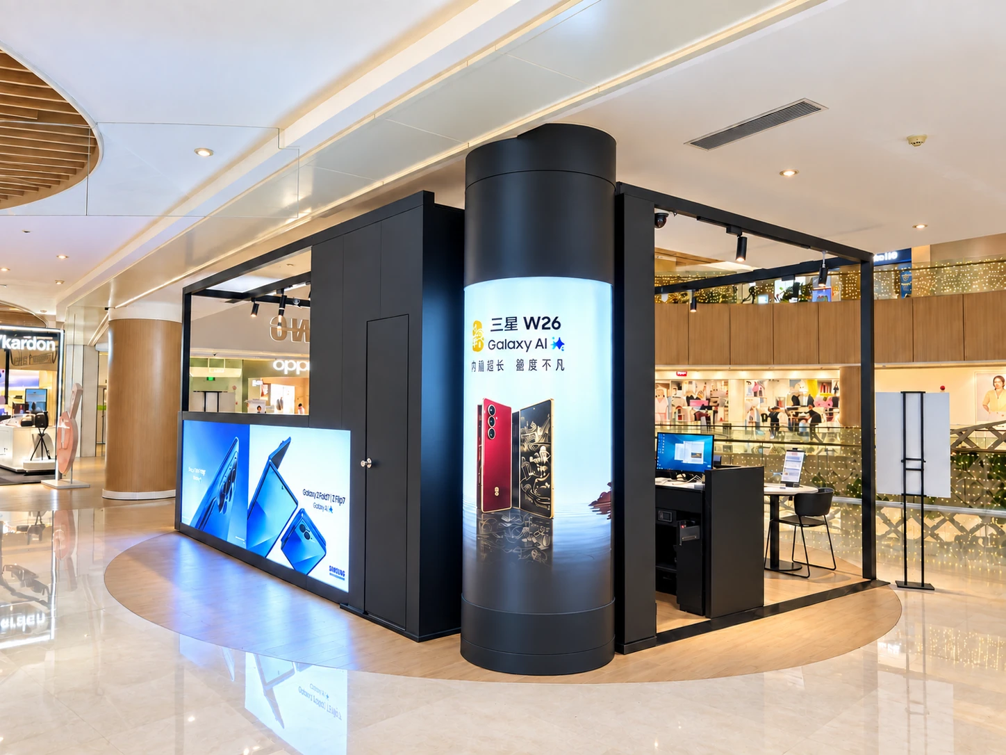 Rounded shop-in-shop corner with vertical screen beside an illuminated graphic