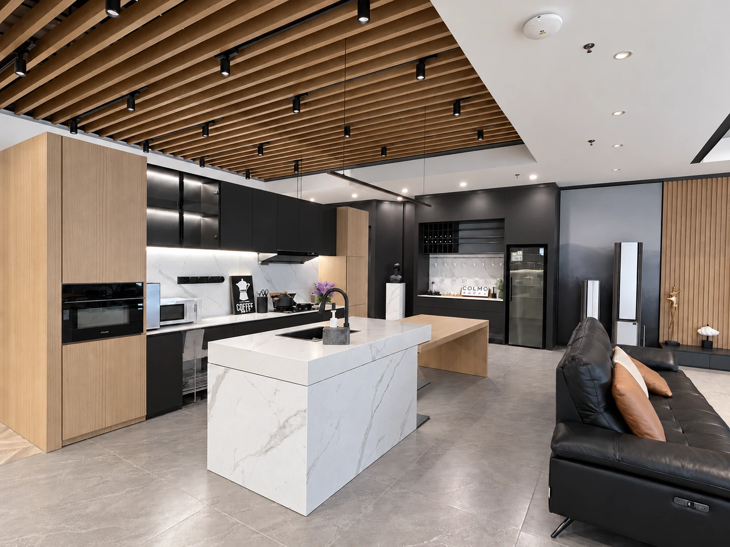 Kitchen island and cabinetry beside a seating area