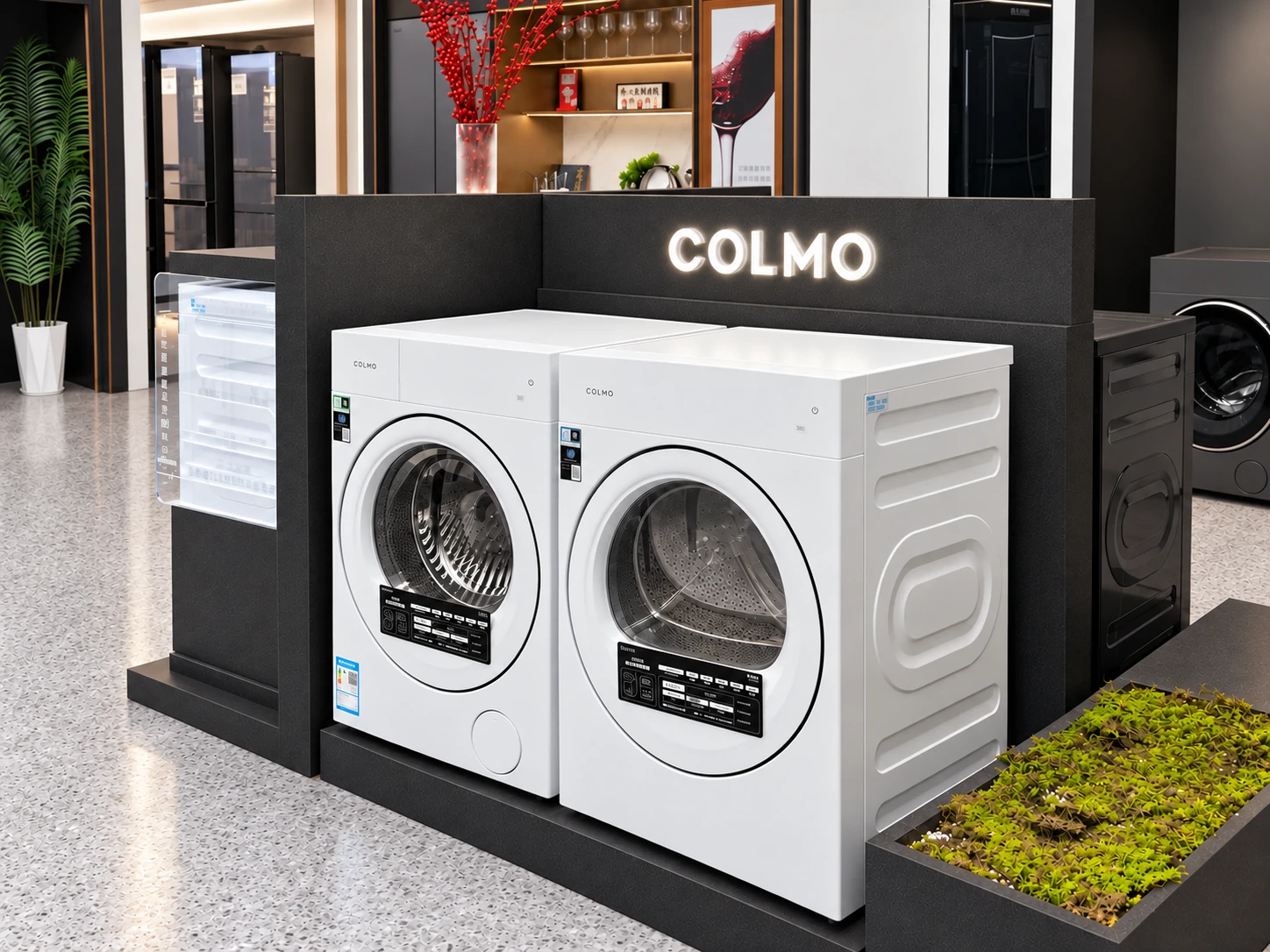 Two front-loading appliances beside a COLMO branded island divider