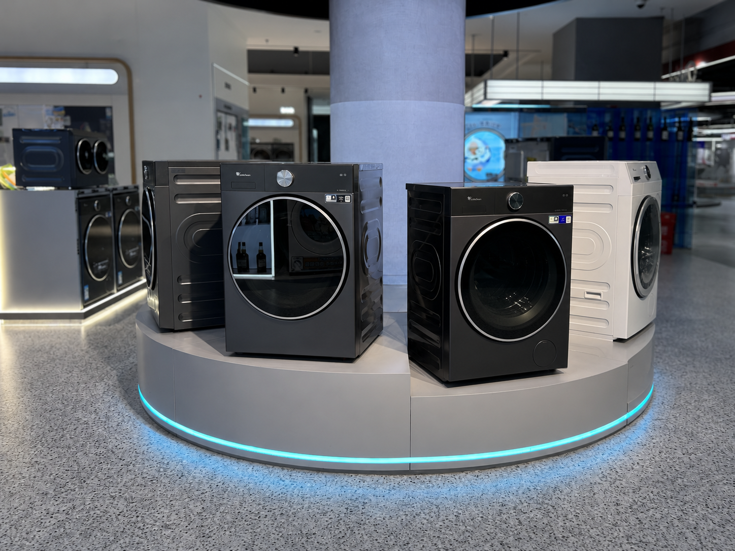 Close view of four Little Swan washers arranged around the curved circular display platform